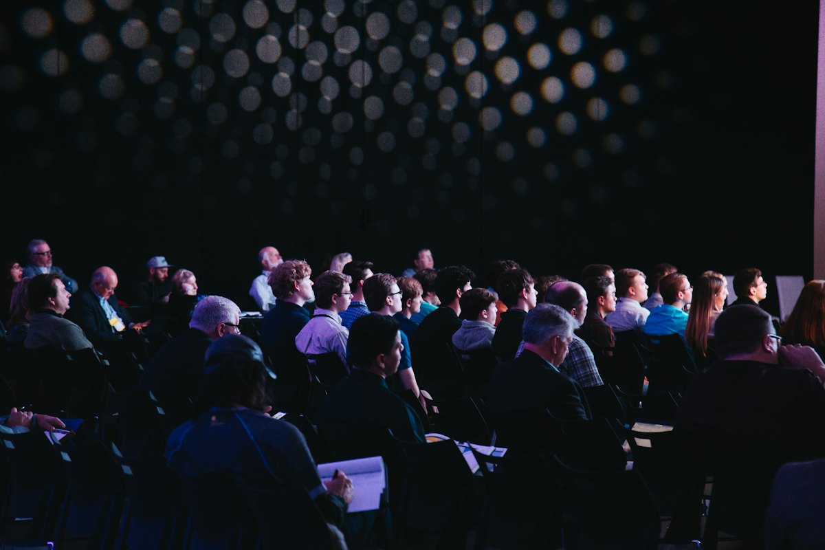 An audience seated at a conference talk